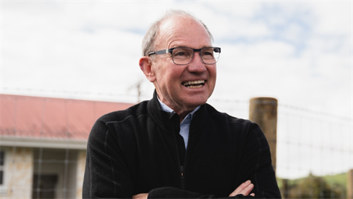 Ian McKelvie in front of a rural backdrop smiling with his arms folded Ian McKelvie in front of a rural backdrop smiling with his arms folded